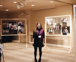 Emily Frazier stands with the nations featured in her stunning photographs